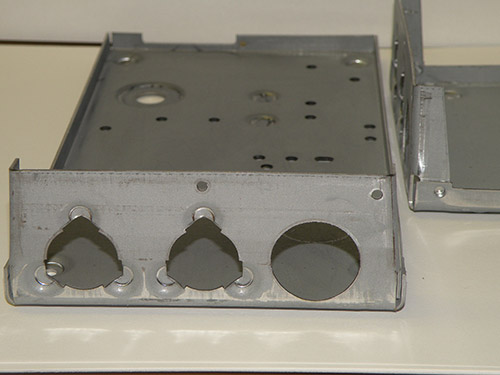 Progressive Die Stamping of a Steel Back Plate for the Consumer Products Industry Progressive Die Stamping of a Steel Back Plate for the Consumer Products Industry